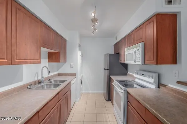 a kitchen with a sink stove top oven and cabinets