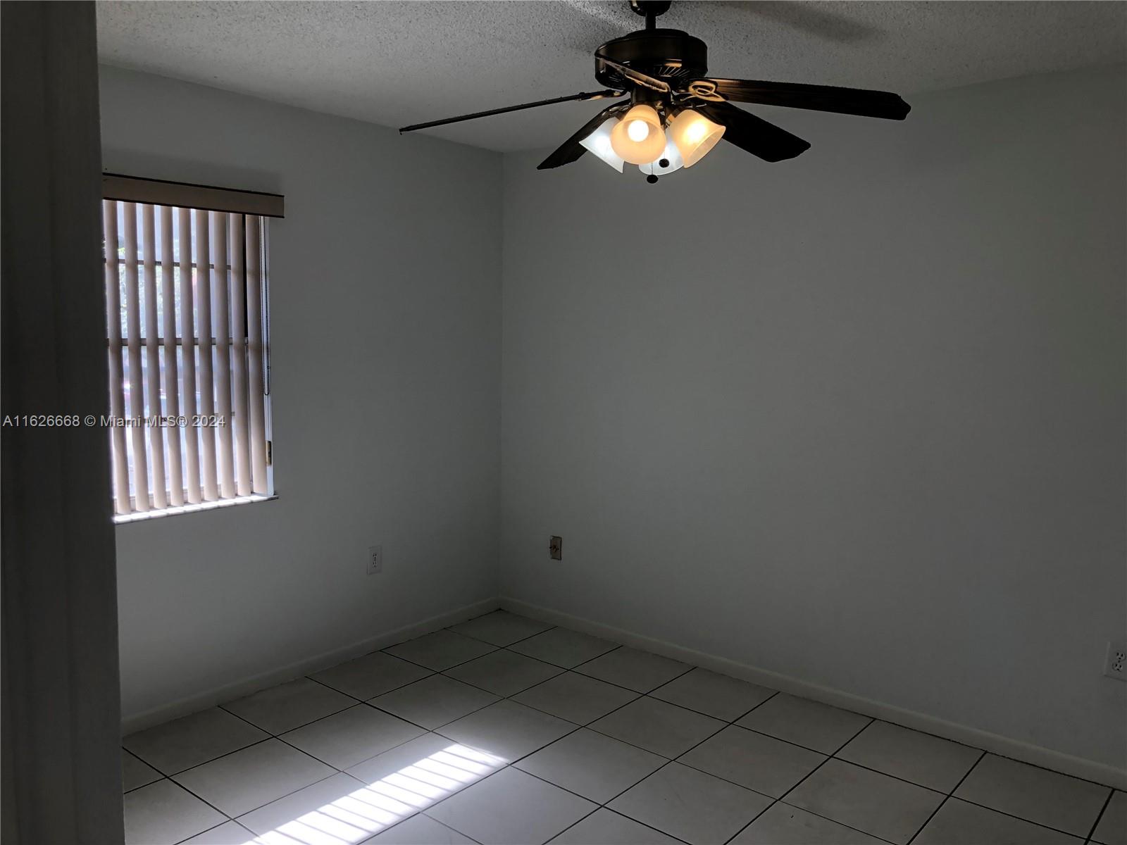 6901 Southwest 129th Avenue, Unit 5 Miami, FL 33183 - Photo 12 of 19 a view of empty room with window