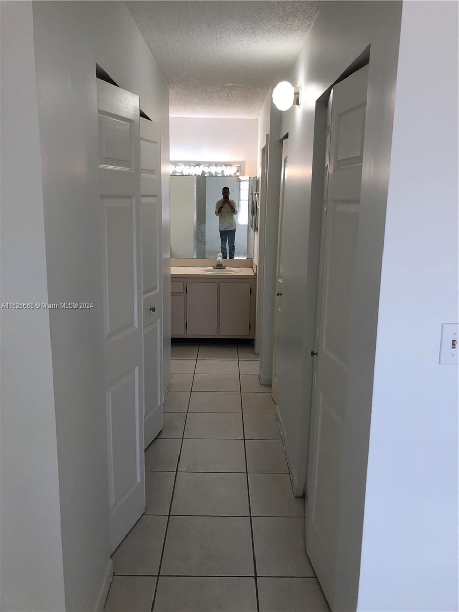 6901 Southwest 129th Avenue, Unit 5 Miami, FL 33183 - Photo 13 of 19 a bathroom with a mirror a sink and a mirror
