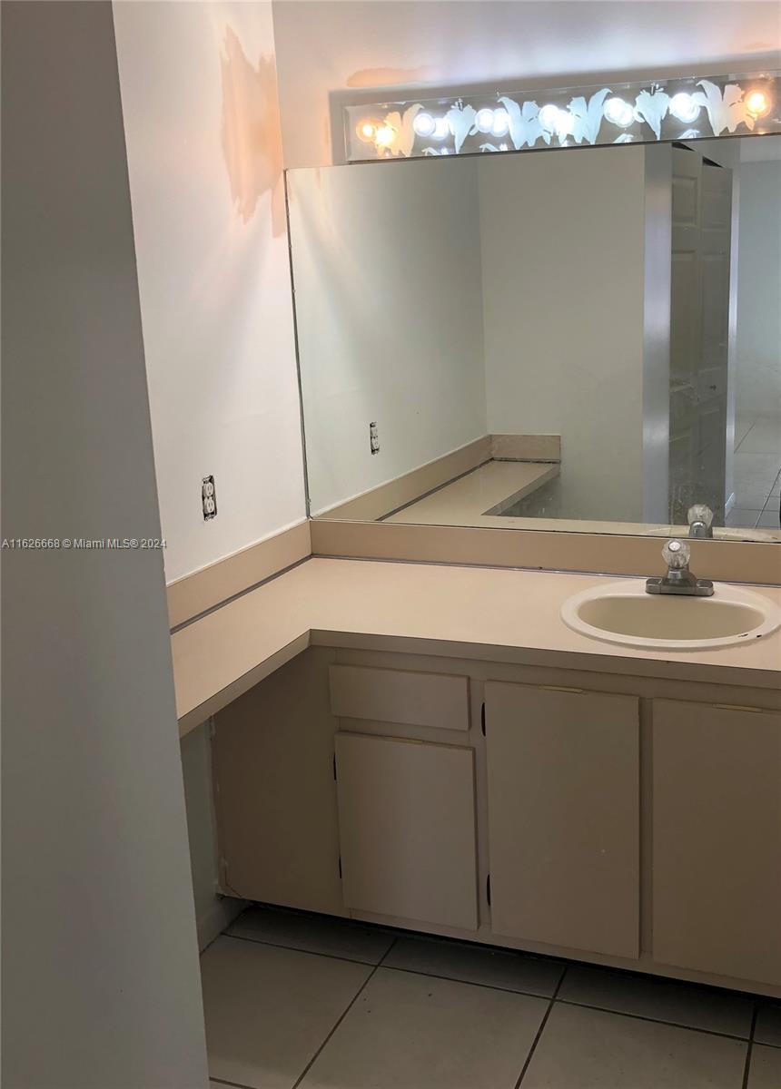 6901 Southwest 129th Avenue, Unit 5 Miami, FL 33183 - Photo 14 of 19 a bathroom with a sink and mirror
