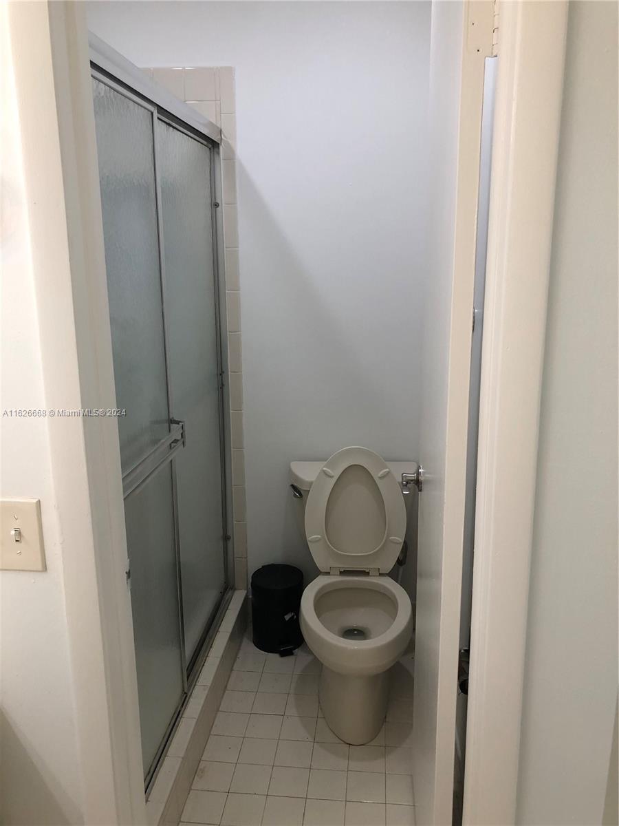 6901 Southwest 129th Avenue, Unit 5 Miami, FL 33183 - Photo 15 of 19 a white toilet sitting next to a shower