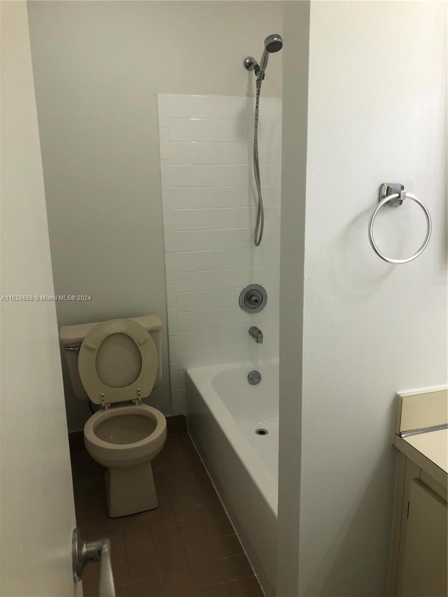 6901 Southwest 129th Avenue, Unit 5 Miami, FL 33183 - Photo 19 of 19 a bathroom with a granite countertop toilet a sink and bathtub