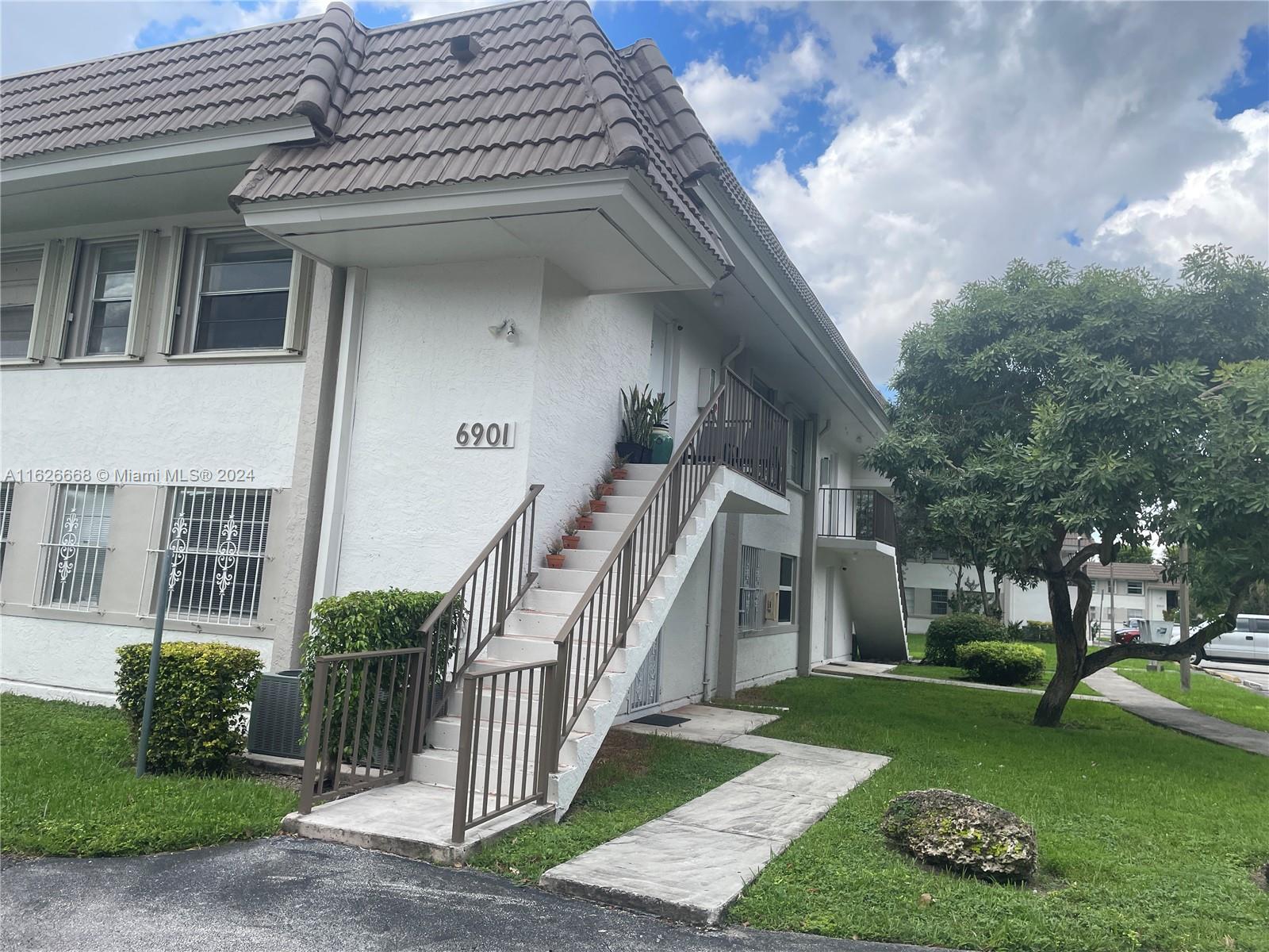 6901 Southwest 129th Avenue, Unit 5 Miami, FL 33183 - Photo 3 of 19 a view of a house with a yard