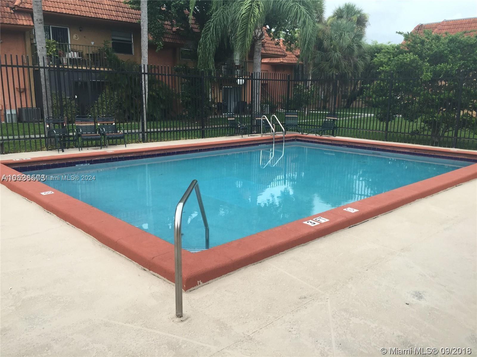 6901 Southwest 129th Avenue, Unit 5 Miami, FL 33183 - Photo 6 of 19 a view of a swimming pool with a patio