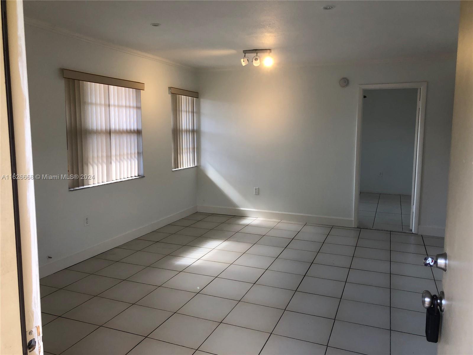 6901 Southwest 129th Avenue, Unit 5 Miami, FL 33183 - Photo 7 of 19 an empty room with windows