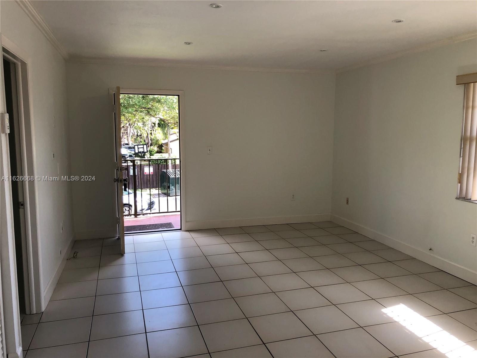 6901 Southwest 129th Avenue, Unit 5 Miami, FL 33183 - Photo 8 of 19 a view of an empty room and window