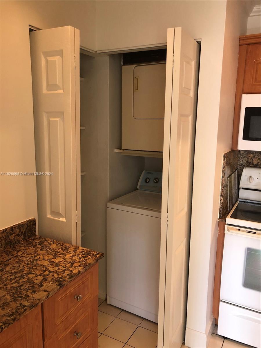 6901 Southwest 129th Avenue, Unit 5 Miami, FL 33183 - Photo 9 of 19 a bedroom with a stove and a refrigerator
