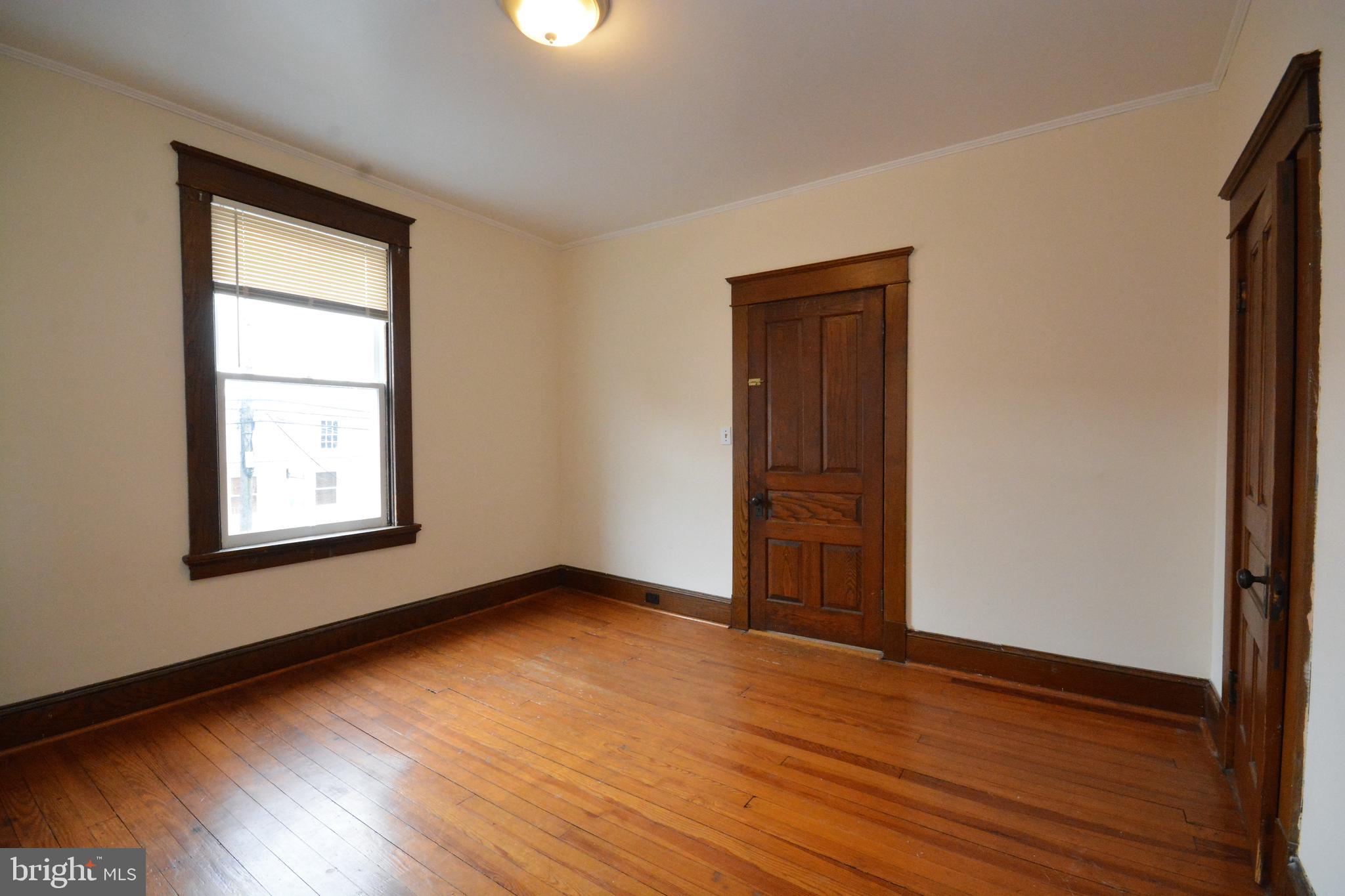 5 West Main Street, Unit 4 Middletown, MD 21769 - Photo 6 of 9 an empty room with wooden floor and windows