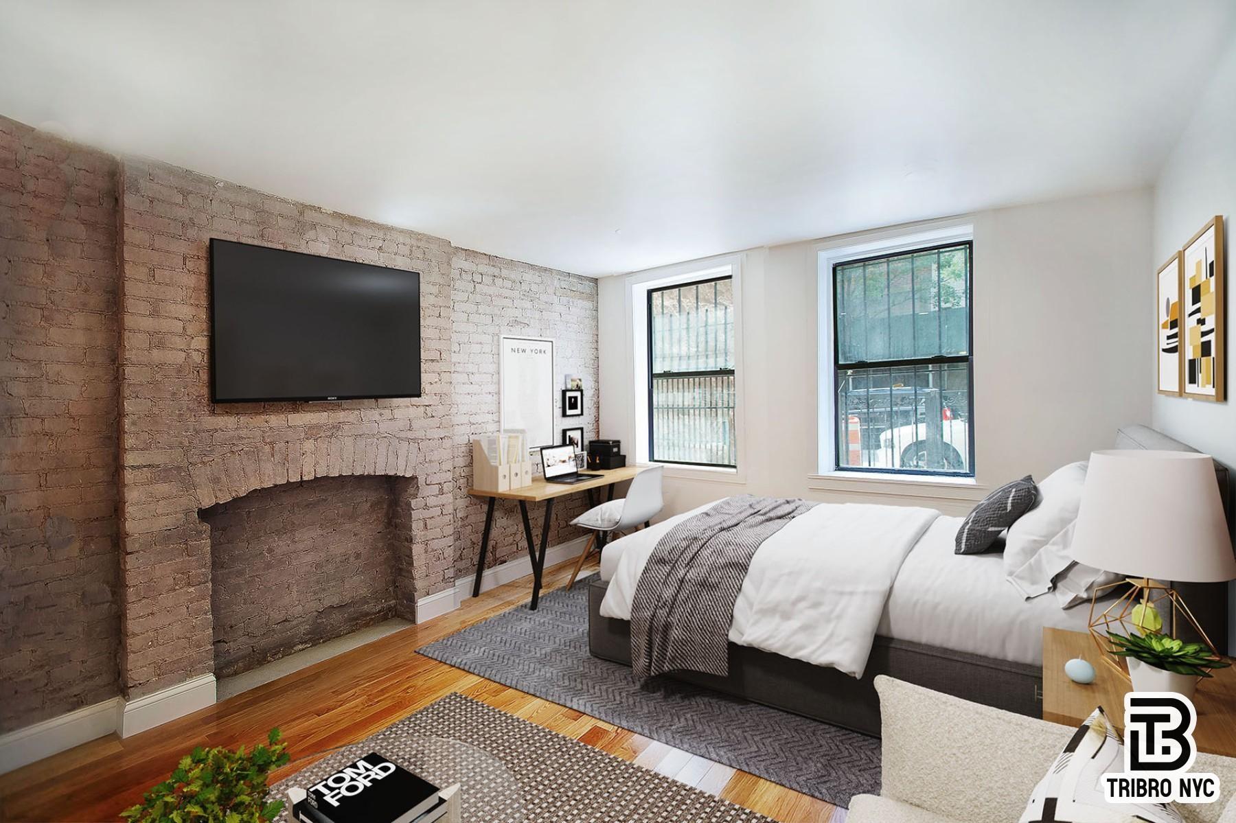 a bedroom with a bed and a fireplace