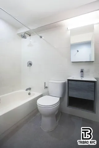 a bathroom with a toilet a sink and bathtub