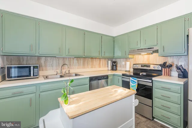 a kitchen with a cabinets and white appliances