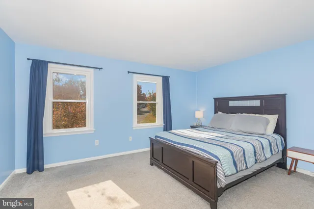 a bedroom with a bed lamp and window