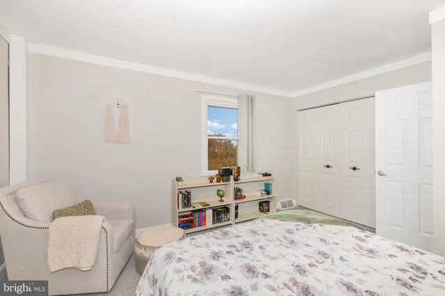 a bed room with a bed and a chair