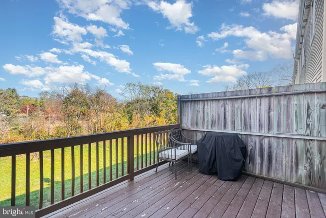 a balcony with wooden floor and fence