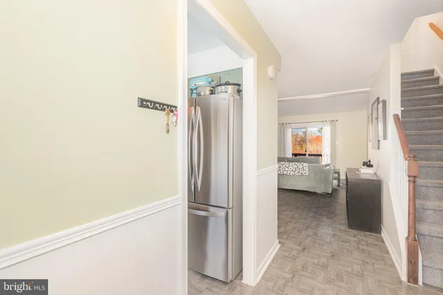 a view of a hallway with a livingroom and a bathroom