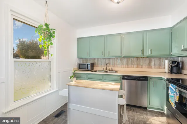 a kitchen with stainless steel appliances granite countertop a sink and a stove
