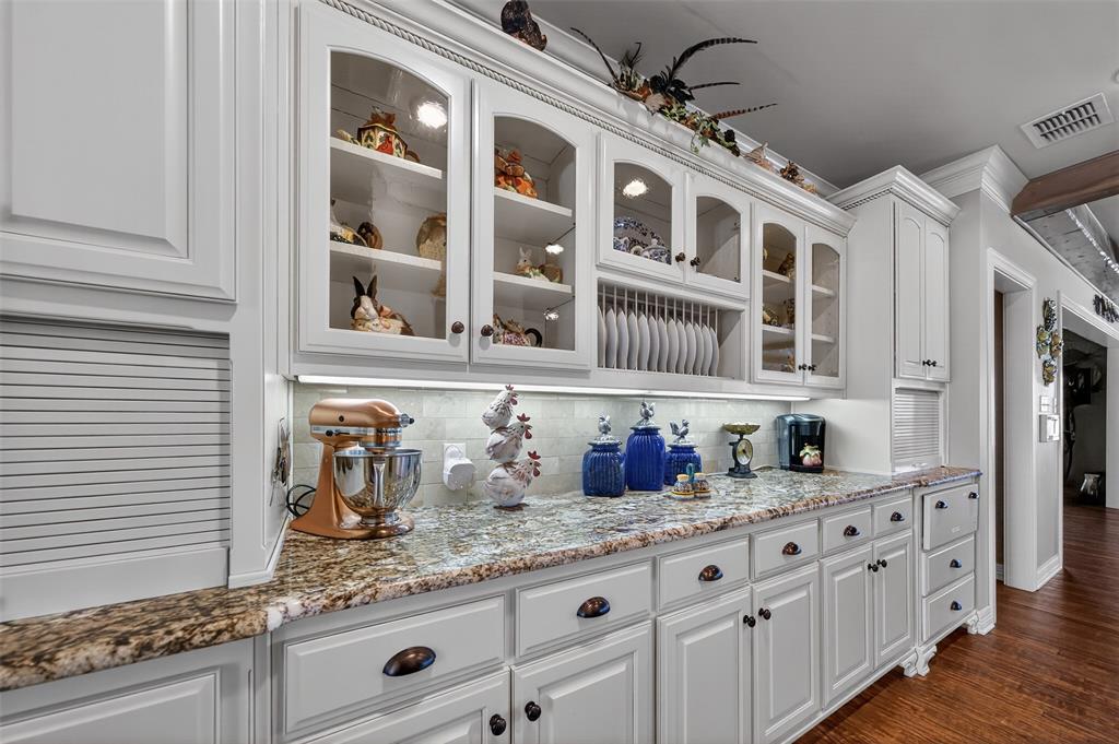 535 Riata Road Bullard, TX 75757 - Photo 12 of 40 a kitchen with granite countertop a sink and cabinets