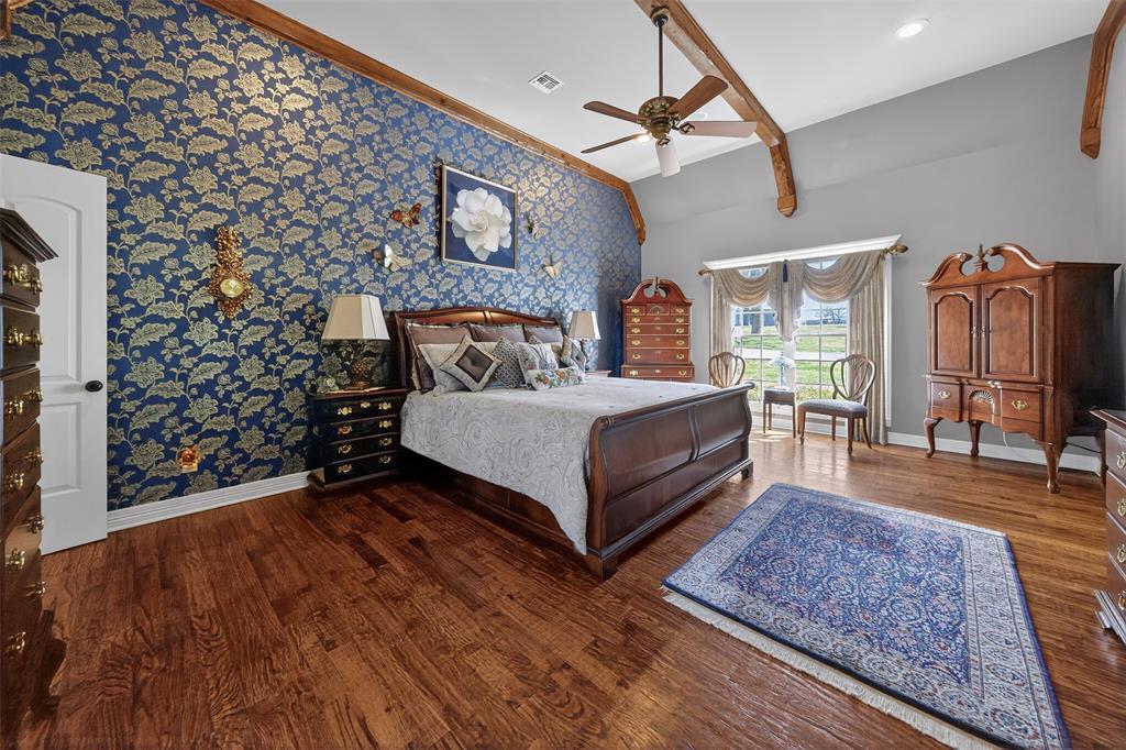 535 Riata Road Bullard, TX 75757 - Photo 16 of 40 a bedroom with a bed wooden floor and window