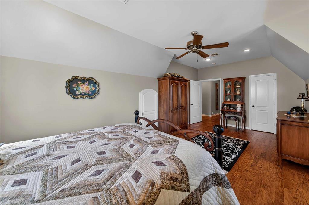 535 Riata Road Bullard, TX 75757 - Photo 19 of 40 a bedroom with a bed dresser and a walk in closet