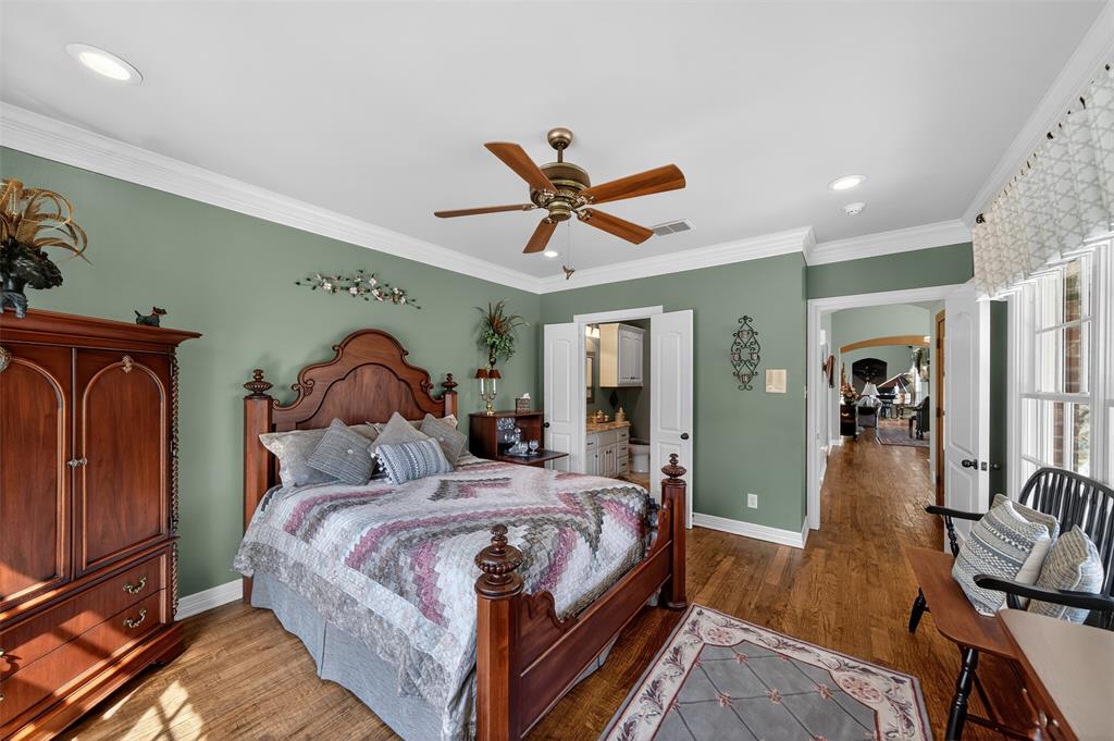 535 Riata Road Bullard, TX 75757 - Photo 23 of 40 a bedroom with a bed and a chandelier