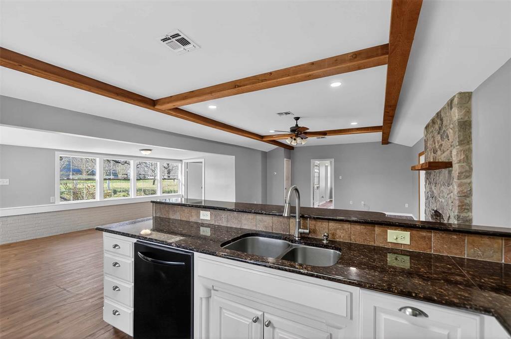 535 Riata Road Bullard, TX 75757 - Photo 33 of 40 a kitchen with granite countertop a sink and a stove