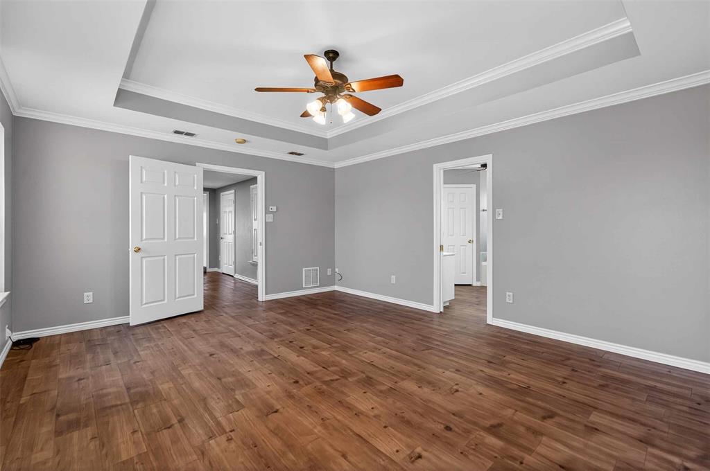 535 Riata Road Bullard, TX 75757 - Photo 34 of 40 a view of an empty room with wooden floor and a ceiling fan