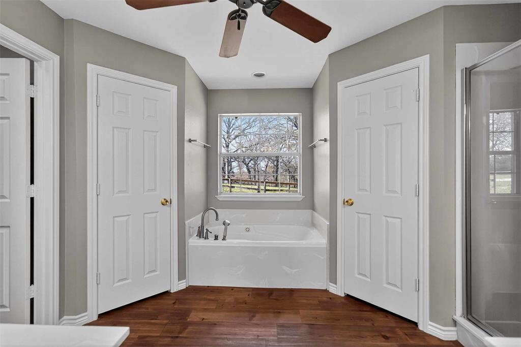 535 Riata Road Bullard, TX 75757 - Photo 36 of 40 a bathroom with a bathtub and a chandelier