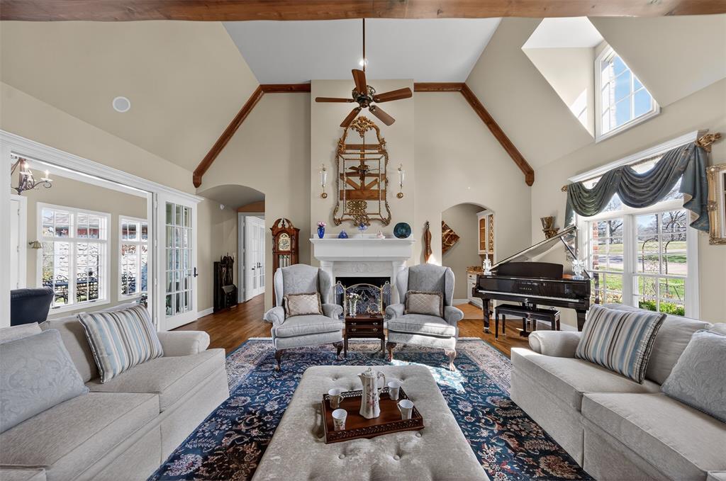 535 Riata Road Bullard, TX 75757 - Photo 7 of 40 a living room with furniture a fireplace and a chandelier