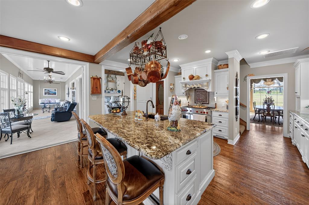 535 Riata Road Bullard, TX 75757 - Photo 8 of 40 a kitchen with stainless steel appliances granite countertop table chairs and wooden floor