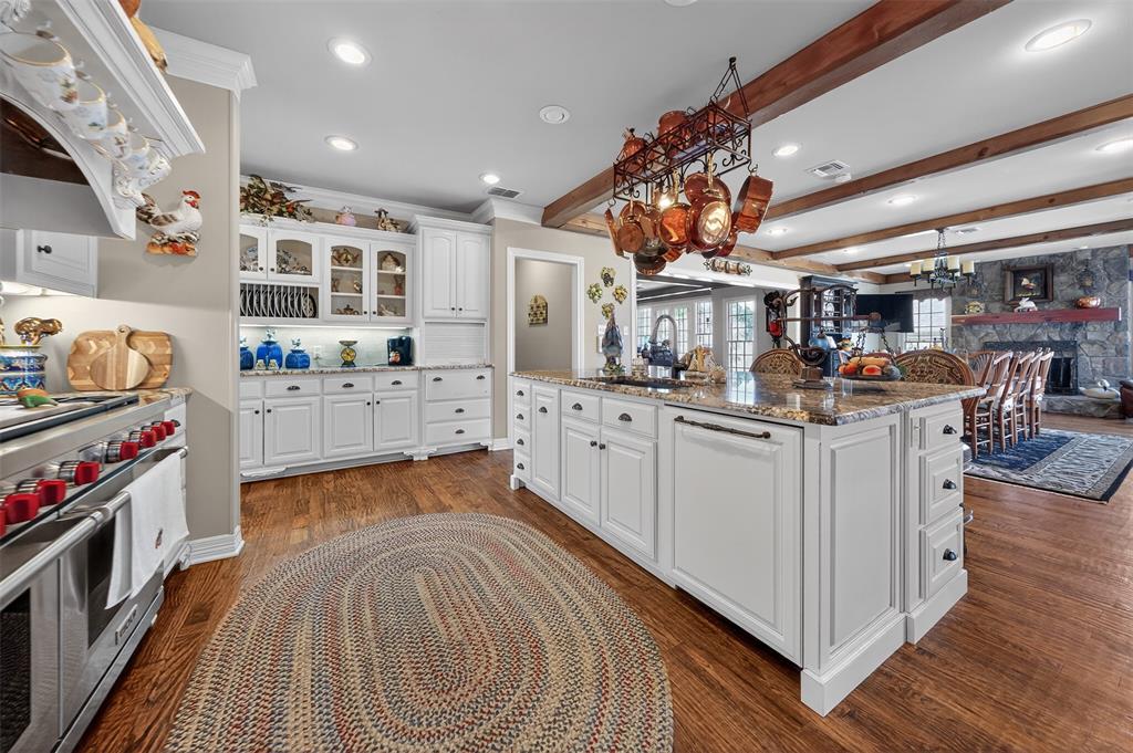 535 Riata Road Bullard, TX 75757 - Photo 10 of 40 a kitchen with stainless steel appliances kitchen island granite countertop a sink and cabinets