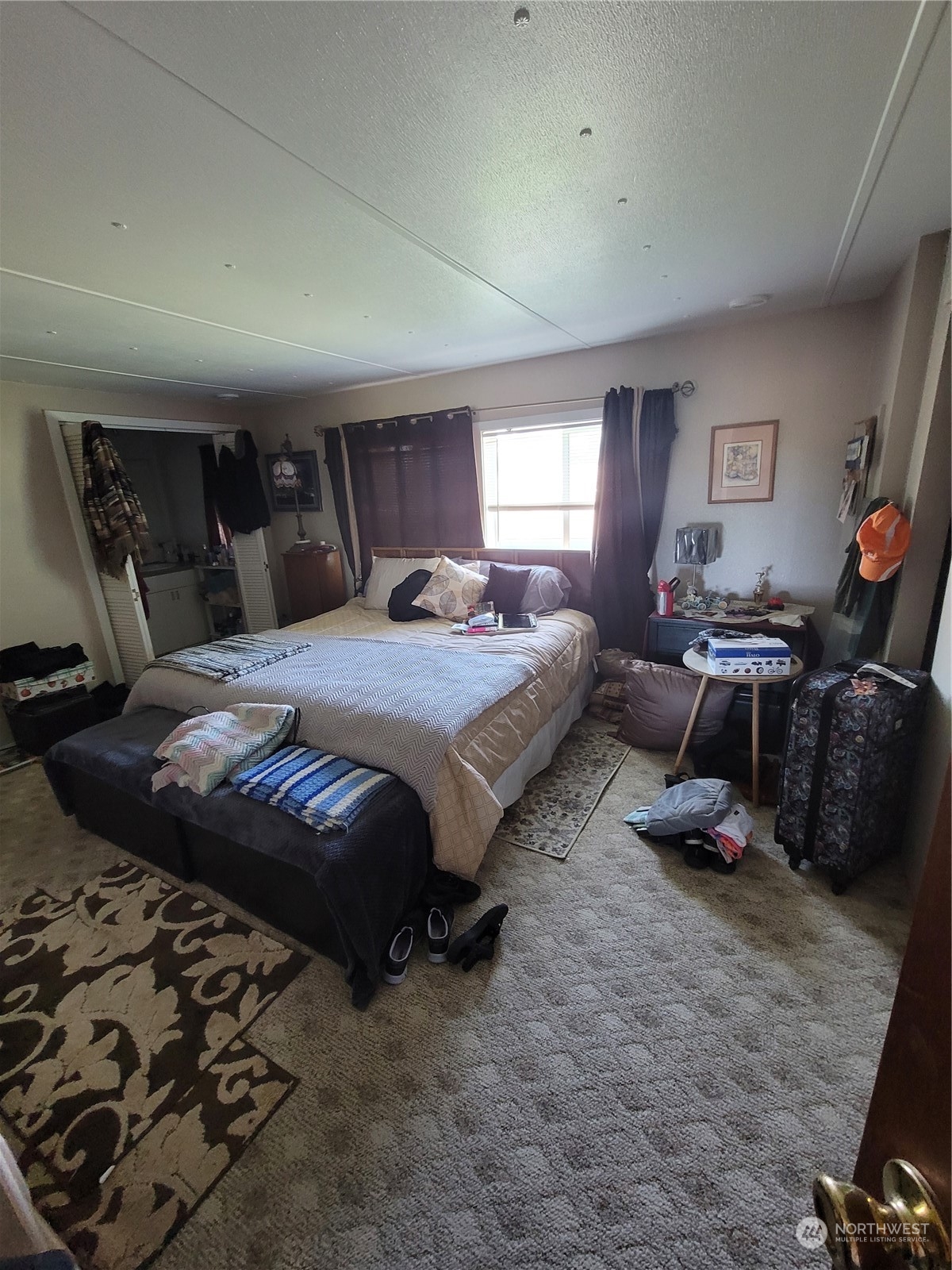 375 Union Avenue Southeast, Unit 36 Renton, WA 98059 - Photo 14 of 25 a bedroom with a bed a couch and dresser