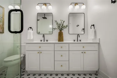 a bathroom with sink mirror and toilet