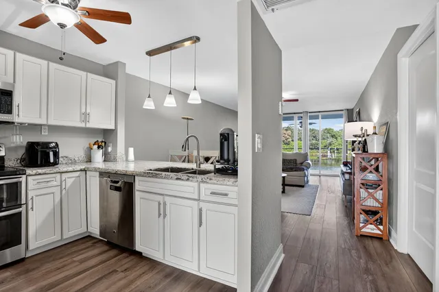 a kitchen with a stove a refrigerator and a sink