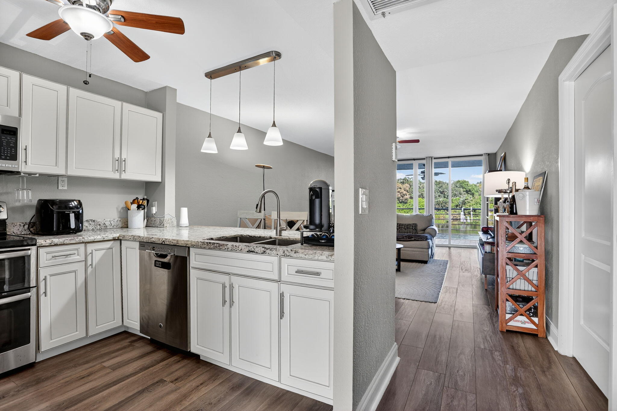 9450 Poinciana Place, Unit 203 Davie, FL 33324 - Photo 11 of 32 a kitchen with a stove a refrigerator and a sink
