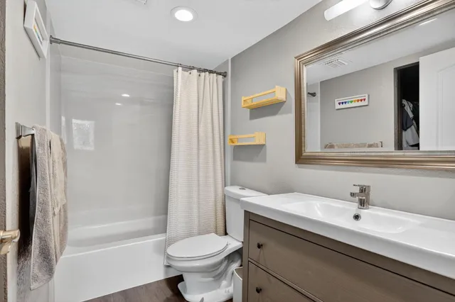 a bathroom with a sink toilet a mirror and shower