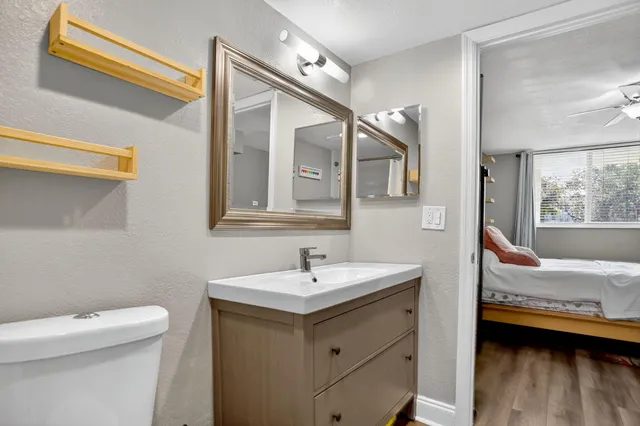 a en suite bathroom with a sink and a mirror