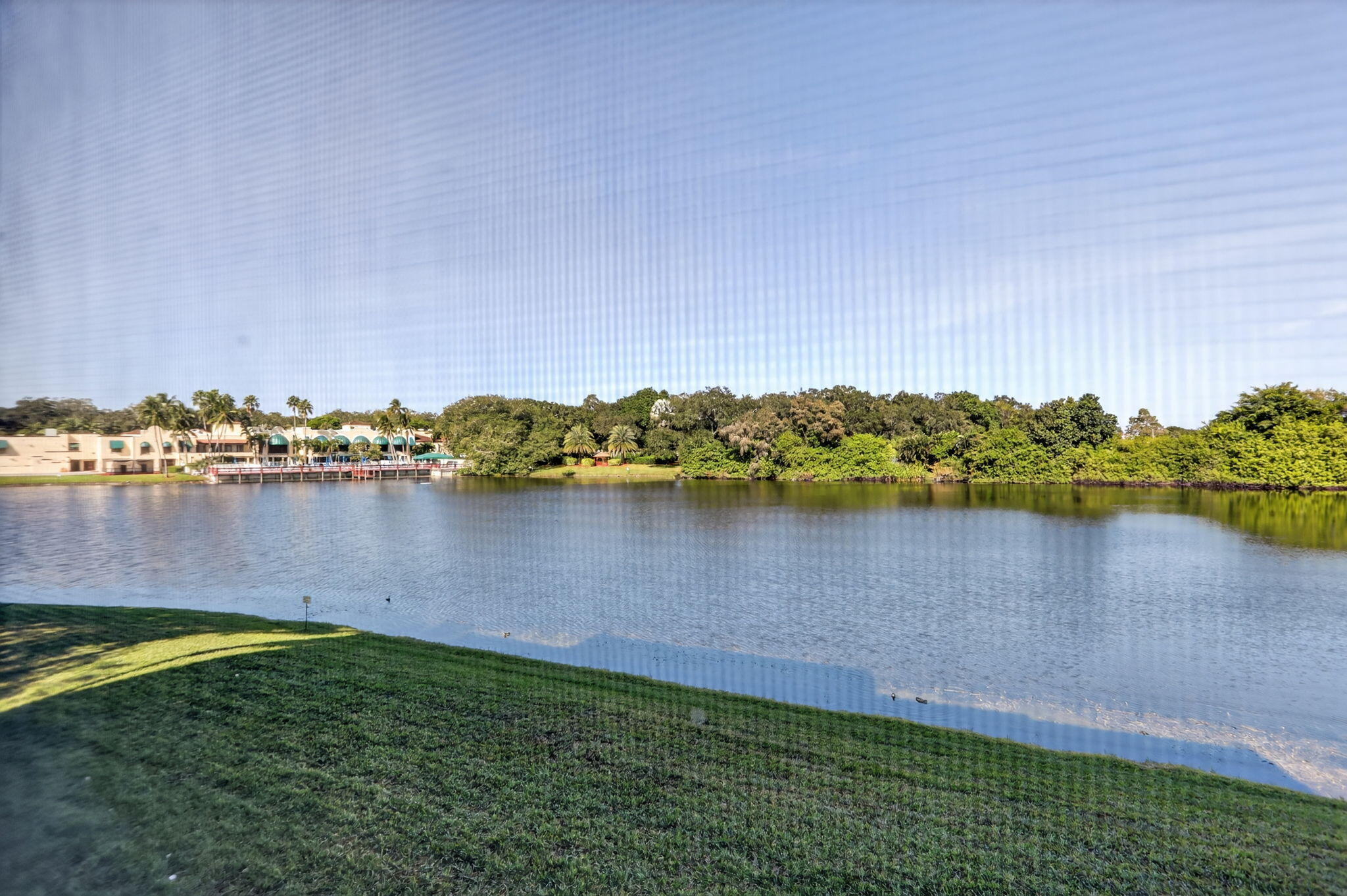 9450 Poinciana Place, Unit 203 Davie, FL 33324 - Photo 23 of 32 a view of a lake with houses in the back
