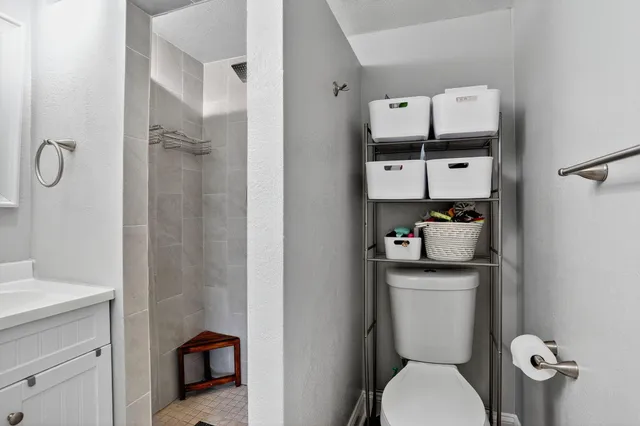 a white toilet sitting next to a bathroom sink