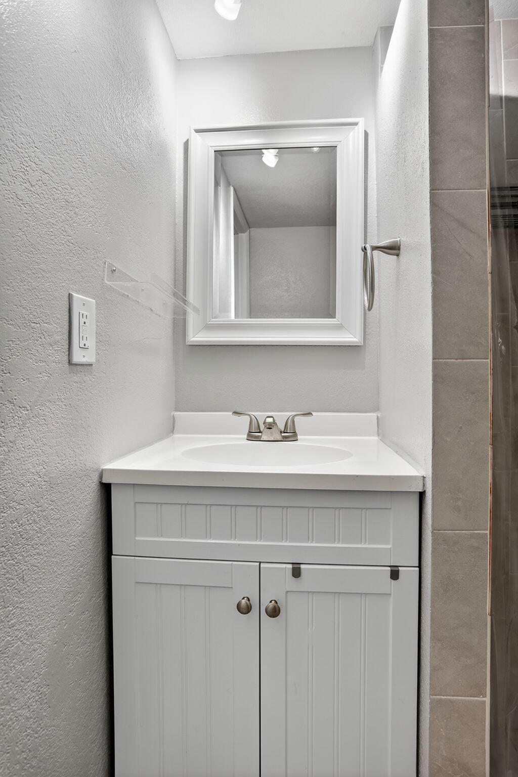 9450 Poinciana Place, Unit 203 Davie, FL 33324 - Photo 25 of 32 a bathroom with a sink and a mirror