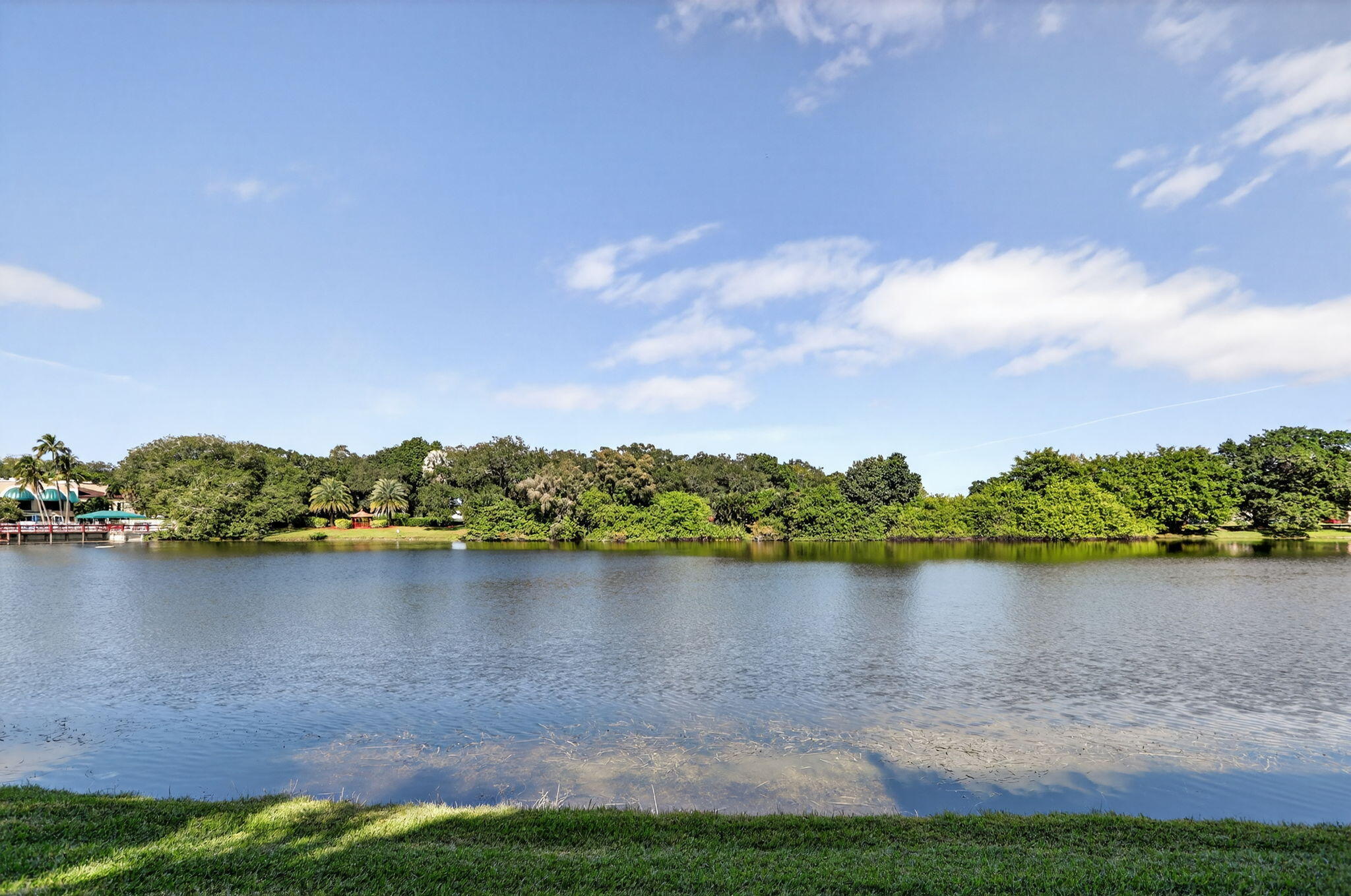 9450 Poinciana Place, Unit 203 Davie, FL 33324 - Photo 30 of 32 a view of a lake with houses in the back
