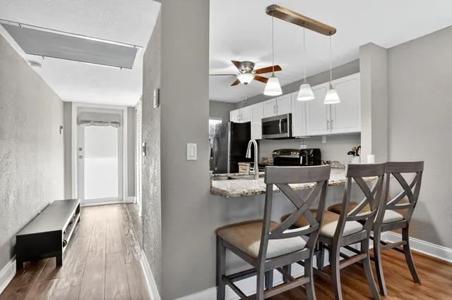 a view of a dining room with furniture and wooden floor