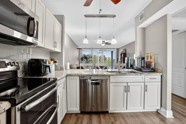 a kitchen with stainless steel appliances granite countertop a stove and a sink