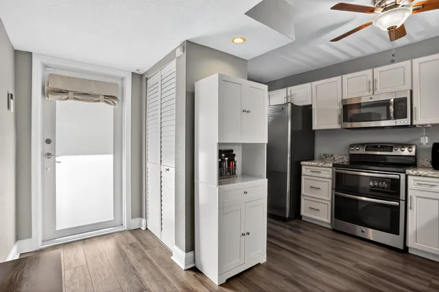 a kitchen with stainless steel appliances a refrigerator and a stove top oven