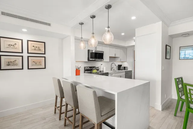 a view of kitchen with cabinets and wooden floor