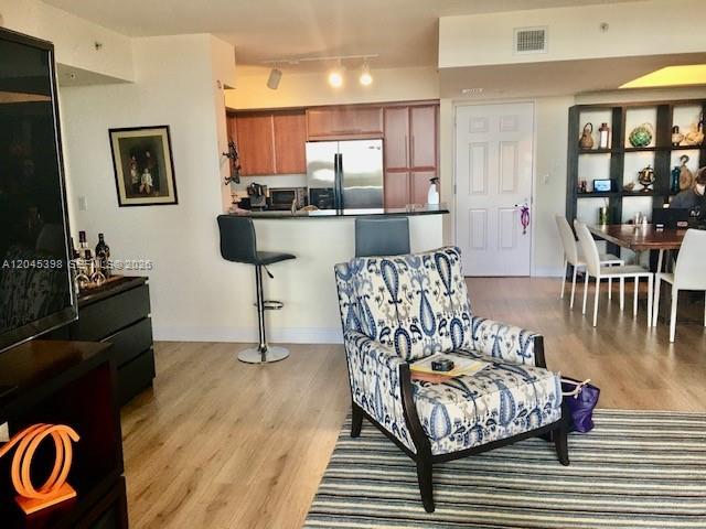 3232 Southwest 22nd Terrace, Unit 1303 Miami, FL 33145 - Photo 13 of 43 a living room with furniture and a wooden floor