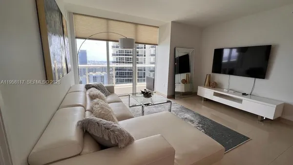 a living room with furniture and a flat screen tv
