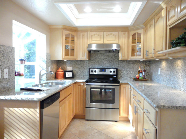 5233 Country Forge Lane San Jose, CA 95136 - Photo 12 of 25 a kitchen with stainless steel appliances granite countertop a sink stove and cabinets