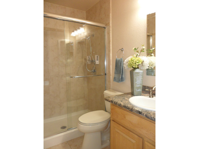 5233 Country Forge Lane San Jose, CA 95136 - Photo 20 of 25 a bathroom with a granite countertop sink a toilet and shower