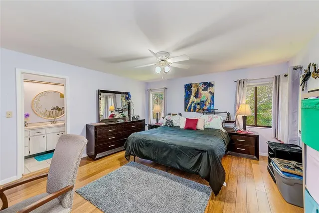 a bedroom with a bed and wooden floor