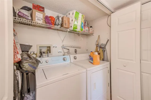 a view of storage and utility room with washer and dryer